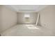 Unfinished bedroom featuring tray ceiling, window, and white walls at 2581 Se 75Th Blvd, Bushnell, FL 33513