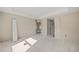 A light-filled bedroom showcasing a tray ceiling, neutral-colored walls, and an open doorway at 2581 Se 75Th Blvd, Bushnell, FL 33513