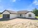 Beautiful single-story home featuring an attached garage and traditional architectural design under a sunny blue sky at 2581 Se 75Th Blvd, Bushnell, FL 33513