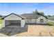 Attractive single-Gathering house with a two-car garage featuring neutral colors and modern design elements at 2581 Se 75Th Blvd, Bushnell, FL 33513