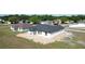Well-lit exterior shot of a newly built home with white columns and dark gray roof at 2581 Se 75Th Blvd, Bushnell, FL 33513