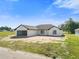 Beautiful single-story home showcasing an attached garage and traditional architectural design under a blue sky at 2581 Se 75Th Blvd, Bushnell, FL 33513