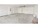 Unfinished garage with concrete floors, white walls, and two doors at 2581 Se 75Th Blvd, Bushnell, FL 33513