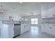 Modern kitchen with white cabinetry, stainless steel appliances, and a large island with bar seating at 2581 Se 75Th Blvd, Bushnell, FL 33513