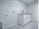 Charming laundry room features a granite vanity, matte black hardware, and modern fixtures at 2581 Se 75Th Blvd, Bushnell, FL 33513