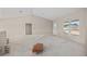 Unfinished living room with vaulted ceiling, white door, and window at 2581 Se 75Th Blvd, Bushnell, FL 33513