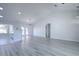 Open living area features modern finishes, including gray wood flooring, granite counters, and recessed lighting at 2581 Se 75Th Blvd, Bushnell, FL 33513