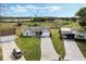 Aerial view featuring a well-maintained home with a long driveway and a manicured lawn at 25818 Belle Alliance, Leesburg, FL 34748