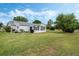 Charming home with a well-maintained lawn and an inviting outdoor patio at 25818 Belle Alliance, Leesburg, FL 34748