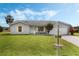 Charming home with a well-manicured lawn, light-grey siding, and inviting curb appeal at 25818 Belle Alliance, Leesburg, FL 34748