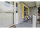 Inviting front porch with seating area and charming details, yellow shutters, and front door at 25818 Belle Alliance, Leesburg, FL 34748
