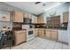 Well-equipped kitchen with tile floors, wood cabinets, granite countertops, and modern appliances for all your culinary needs at 25818 Belle Alliance, Leesburg, FL 34748