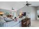 Open-concept living room with new floors, fan, and a comfortable sectional sofa at 25818 Belle Alliance, Leesburg, FL 34748