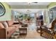 Bright sunroom with large windows, tile floors, ceiling fans, and casual dining and seating areas with views of the outdoors at 25818 Belle Alliance, Leesburg, FL 34748