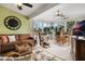 Bright and airy sunroom with a large clock, comfortable furniture, and beautiful views of the surrounding landscape at 25818 Belle Alliance, Leesburg, FL 34748