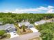 A high-angle aerial view of the house with a blue sky and wooded area background at 26823 Forest Hills St, Leesburg, FL 34788