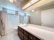 Bright bathroom featuring a shower-tub combo, spacious vanity with dark cabinets, and modern fixtures at 26823 Forest Hills St, Leesburg, FL 34788