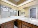 Bathroom with a large vanity and an oversized mirror. Also has a shower-tub combo with white tiling at 26823 Forest Hills St, Leesburg, FL 34788