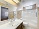 Bathroom featuring a white vanity, glass-enclosed shower and neutral tones with a mirrored wall at 26823 Forest Hills St, Leesburg, FL 34788