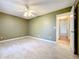 Bedroom with tile floors, a ceiling fan, and an entry to an adjacent hallway at 26823 Forest Hills St, Leesburg, FL 34788