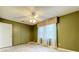 Bedroom with tile floors, a ceiling fan, and a window with curtains at 26823 Forest Hills St, Leesburg, FL 34788