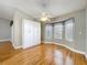 Bedroom offers hardwood floors, a ceiling fan, bay windows with views, and ample storage in the built-in wardrobes at 26823 Forest Hills St, Leesburg, FL 34788