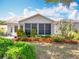A well-maintained house with a screened-in porch surrounded by colorful landscaping, enhancing curb appeal at 26823 Forest Hills St, Leesburg, FL 34788
