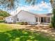 A well-maintained single-Gathering home with a screened porch, back patio and manicured landscaping at 26823 Forest Hills St, Leesburg, FL 34788