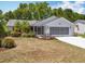 Charming single-story home with a well-manicured lawn and screened garage door at 26823 Forest Hills St, Leesburg, FL 34788
