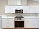 Modern kitchen features stainless steel appliances, white cabinets, and beautiful countertops for cooking and entertaining at 26823 Forest Hills St, Leesburg, FL 34788