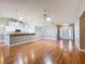 Open-concept living room with wood floors, seamlessly connected to the kitchen at 26823 Forest Hills St, Leesburg, FL 34788