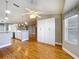 Bright and open living room with wood floors, storage and views into the kitchen with stainless appliances at 26823 Forest Hills St, Leesburg, FL 34788