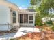 An enclosed porch features screen windows and a concrete patio, extending the living space to the outdoors at 26823 Forest Hills St, Leesburg, FL 34788