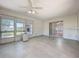 Sunroom with tile flooring, ceiling fan and sliding glass door, providing serene views and easy access to outdoors at 26823 Forest Hills St, Leesburg, FL 34788