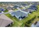 Aerial view of a home showcasing backyard, screened lanai, and neighborhood at 2775 Navy Hill Cir, The Villages, FL 32163