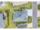 An aerial shot shows the roof and backyard of a home with green grass and close proximity to other homes at 2775 Navy Hill Cir, The Villages, FL 32163
