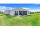 Spacious backyard with a covered patio and lush green grass at 2775 Navy Hill Cir, The Villages, FL 32163