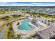 Aerial shot of the community pool surrounded by lounge chairs and palm trees, perfect for relaxation at 2775 Navy Hill Cir, The Villages, FL 32163
