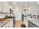 Well-lit kitchen with white cabinets, modern appliances, and a sleek design for seamless cooking at 2775 Navy Hill Cir, The Villages, FL 32163