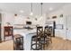 Bright kitchen with white cabinets, stainless steel appliances, and a center island with bar stool seating at 2775 Navy Hill Cir, The Villages, FL 32163