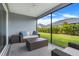 Relaxing screened lanai with comfortable seating, coffee table and view of the backyard at 2775 Navy Hill Cir, The Villages, FL 32163
