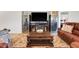 Comfortable living room showcasing a large screen TV and stylish decor, perfect for relaxation at 2775 Navy Hill Cir, The Villages, FL 32163