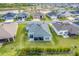 A sunny aerial view of the home showcasing a well-maintained lawn and screened-in patio for outdoor living at 2775 Navy Hill Cir, The Villages, FL 32163
