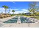 A community shuffleboard court with palm trees and new markings in a well-maintained neighborhood at 2775 Navy Hill Cir, The Villages, FL 32163