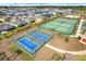 Overhead view of well-kept tennis and paddle ball courts in a vibrant community setting, perfect for active residents at 2775 Navy Hill Cir, The Villages, FL 32163
