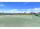 An outdoor tennis court with green surface and new netting for recreational play and neighborhood enjoyment at 2775 Navy Hill Cir, The Villages, FL 32163