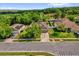 An aerial view of a home with a well-maintained yard, mature trees, and a two-car garage at 2988 Santa Maria Ave, Clermont, FL 34715