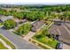 A high-angle aerial showcases the home's driveway, landscaped yard, and neighborhood streets at 2988 Santa Maria Ave, Clermont, FL 34715