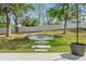A cozy backyard featuring a stone fire pit and a manicured lawn at 2988 Santa Maria Ave, Clermont, FL 34715