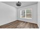 Empty bedroom featuring hardwood style flooring, white walls, and a bright window at 2988 Santa Maria Ave, Clermont, FL 34715